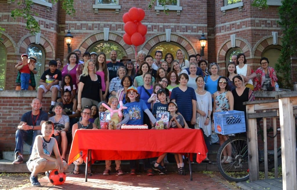 A group of people behind a table outside