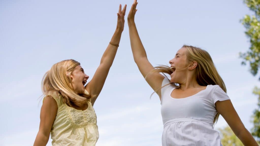 Two girls giving high fives